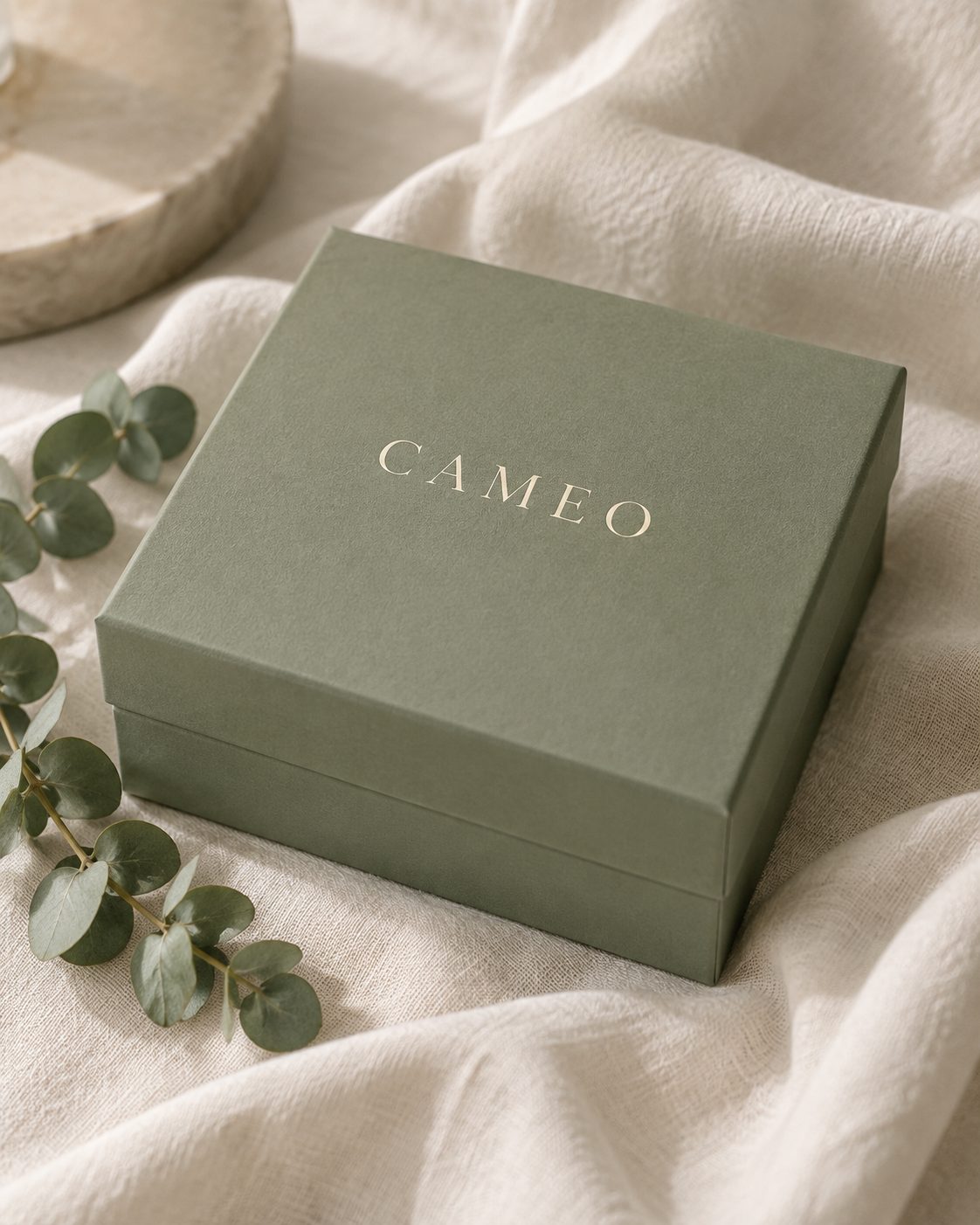 Sage green CAMEO gift box on ivory linen